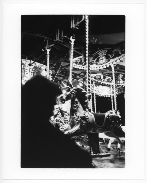Broth Tarn (Sean O’Connell): Man at carousel, London, 2023